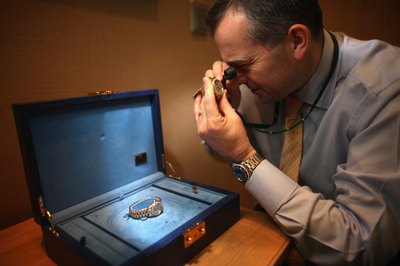 Man examines Rolex watch