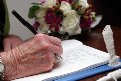 older woman writing on piece of paper