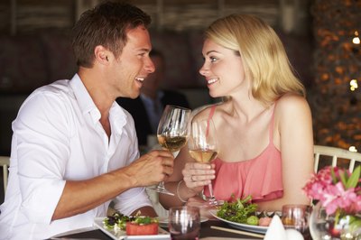 Couple toasting with white wine at restaurant
