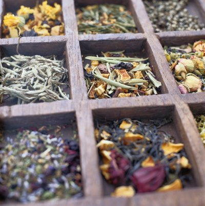 Assemble a basket full of a variety of teas and coffee blends.