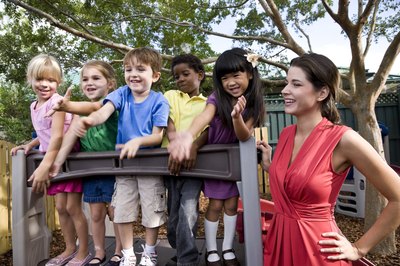 Mother playing outside with children
