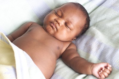 A newborn baby sleeps.
