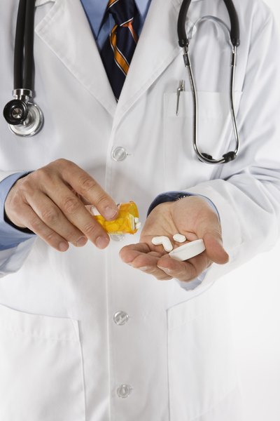 Doctor pouring medicine in hand