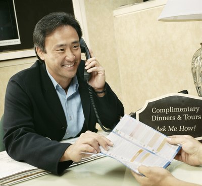 A hotel guest receives assistance at the front desk.