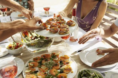 Plate of canapes and smoked salmon appetizers being passed around table