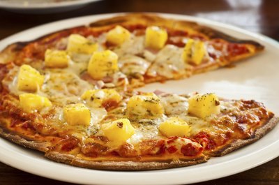 Small Hawaiian pizza on paper plate