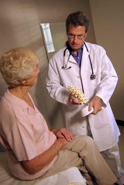 Elderly woman talking to doctor