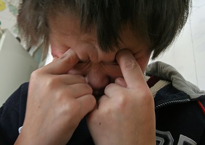 Child suffering from infantile autism reacting