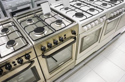 Row of gas ovens in a store.