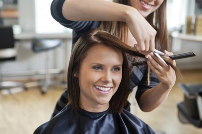 woman getting a haircut in salon