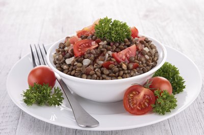 A lentil salad with tomatoes and parsley.