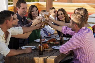 Friends toasting at the table.