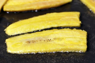 Sliced plantains being fried.