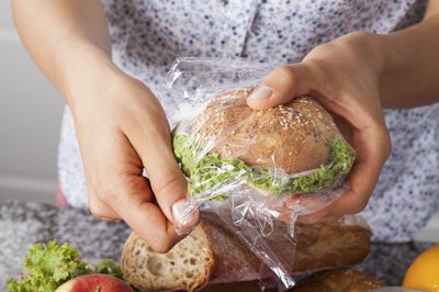 Woman wrapping up sandwich for school lunch