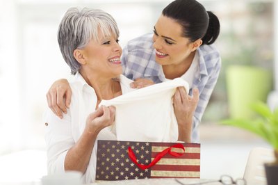 Senior pulling clothes out of gift bag