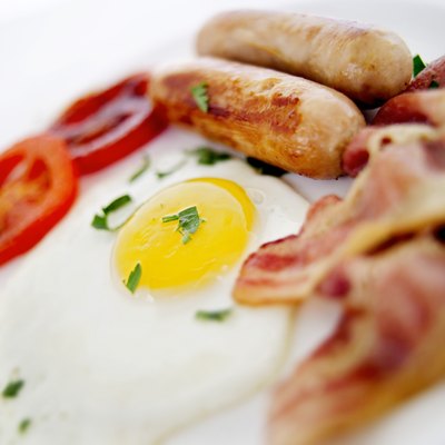 A plate of eggs, bacon, and sausage.