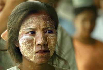 Burmese woman wearing yellow sandalwood paste on skin