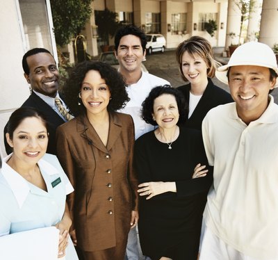 Portrait of a hotel staff standing in front of the hotel.