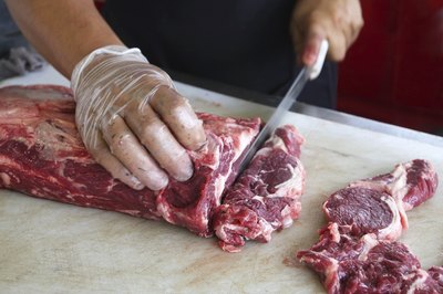 Chef cutting beef