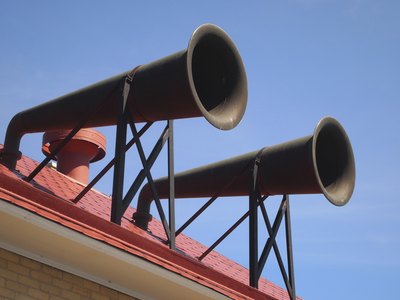 A pair of fog horns on a rooftop.