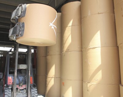 Large spools of paper in manufacturing plant