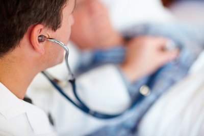 Doctor listening to patient's heartbeat