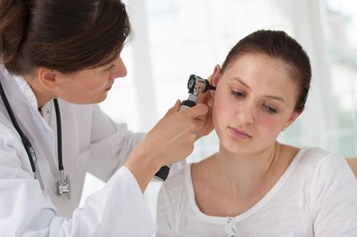 Doctor looking in ear
