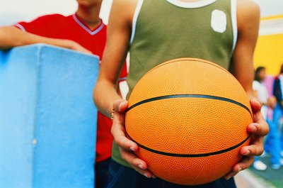 Teen boy holding basketball