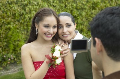 Mother hugging daughter before prom