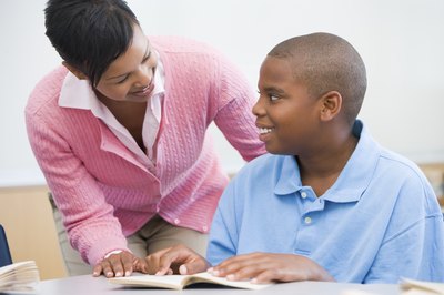 Woman helping boy with homework