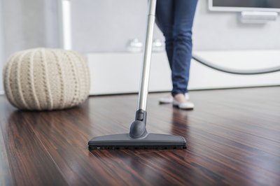 Woman vaccuming living room