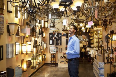 Man browsing light fixtures at store.