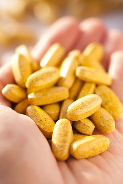 Vitamin C pills in woman's hand