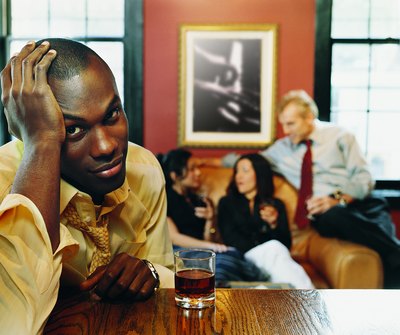 A man has a headache at a party.