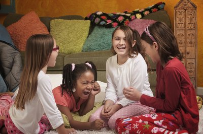 Girls at a slumber party playing a game