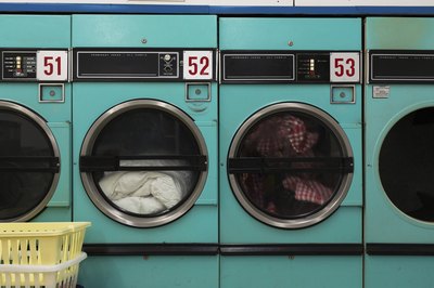 A laundromat with laundry in the washers.