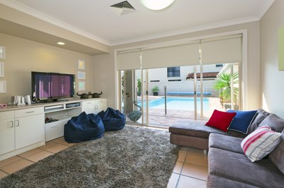 A modern entertainment room with an area rug on the floor.
