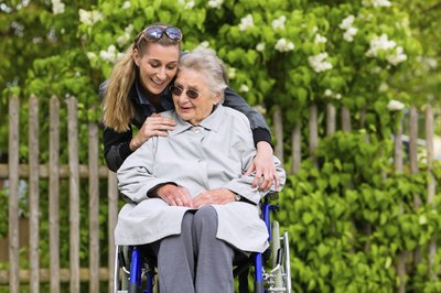 Young woman hugging nursing home resident