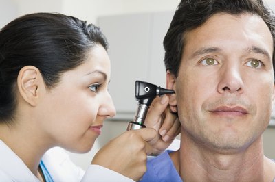 doctor looking in man's ear