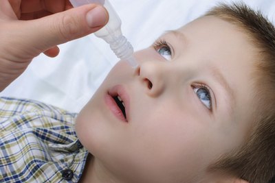 Young boy taking nasal drops