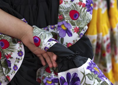 A close-up of women wearing long ruffled skirts.