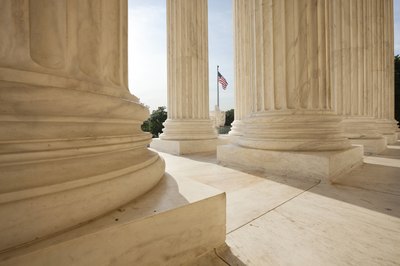 A close-up of pillars in front of the U.S. Supreme Court building.
