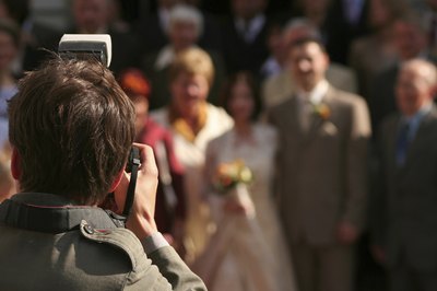 Wedding photographer takes group portrait