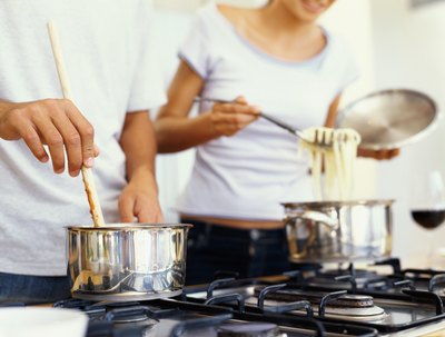 Couple cooking pasta