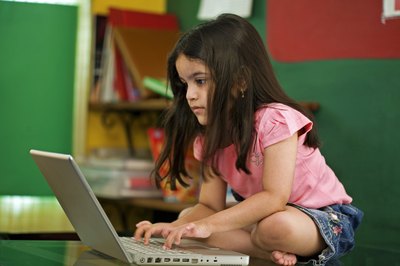 Little girl playing on laptop