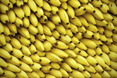 A large stack of bananas at a market