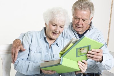 Seniors looking through scrapbook together