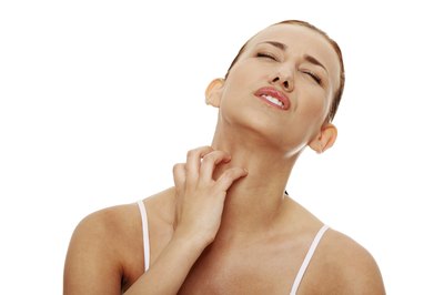 Woman itching from a tick's bite.