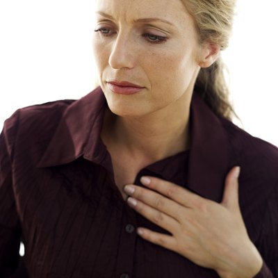 Woman with hand on chest