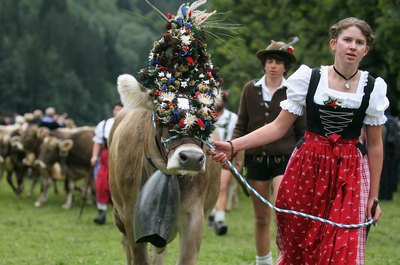 Herdsmen and woman wearing traditional Swiss clothes